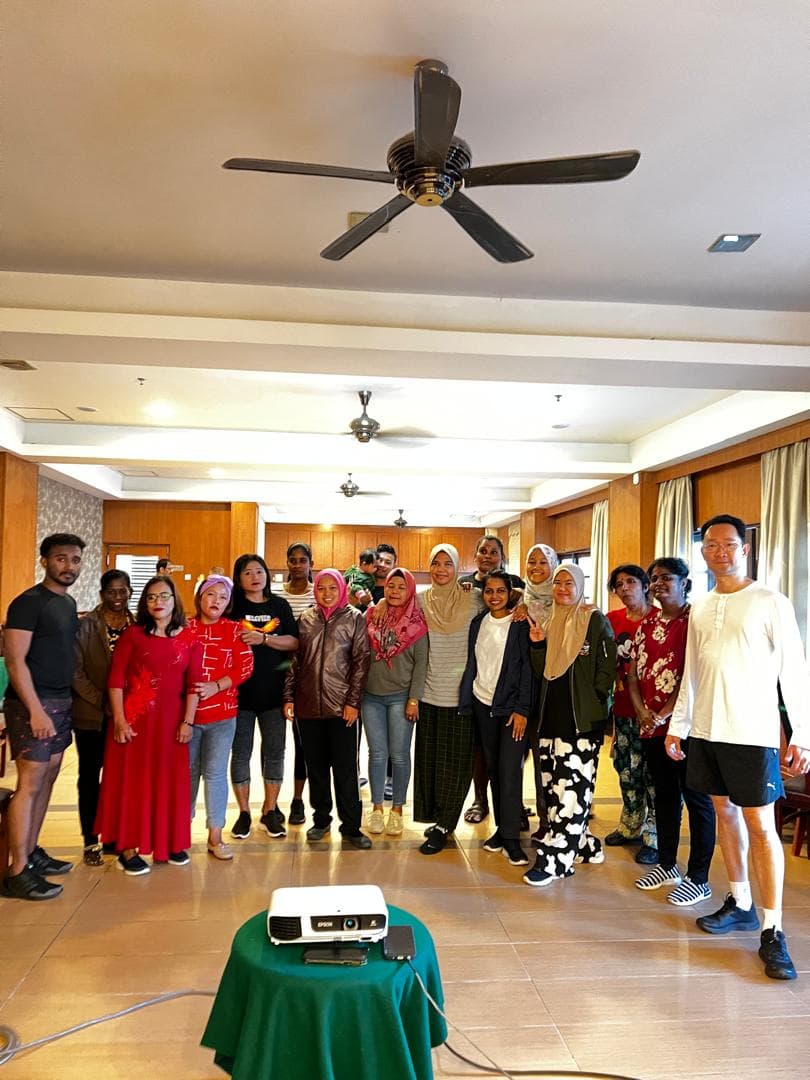 About twenty participants and two Fightlab coaches pose together in a function room after a corporate session.